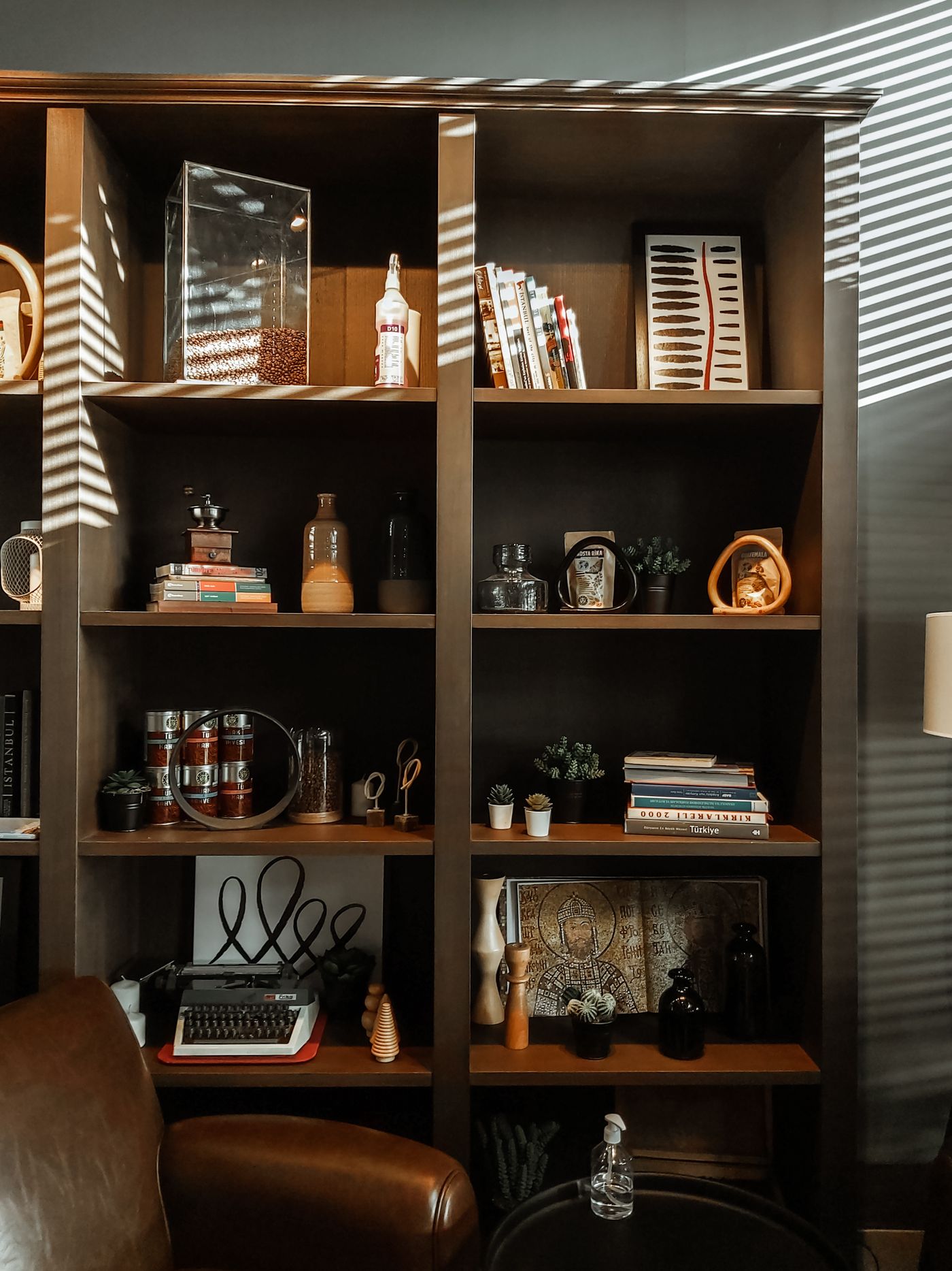 Books and everyday objects arranged in a wooden bookcase.