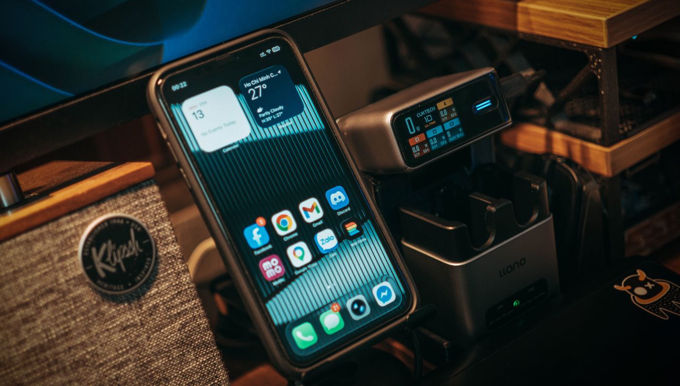 A smartphone sitting upright on a charging stand.