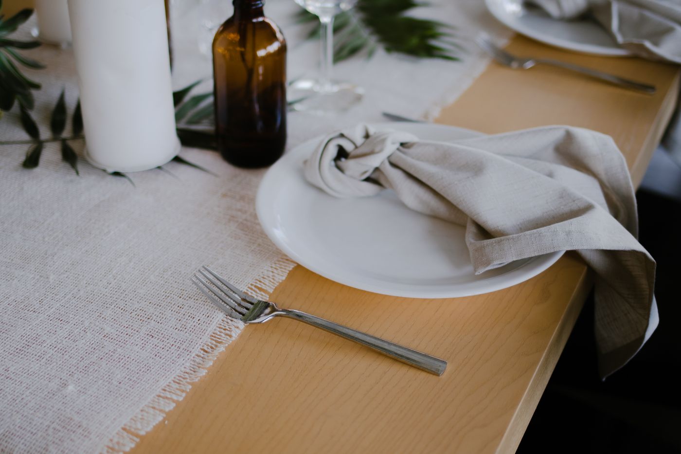 A cloth napkin tied loosely on a dinner plate.