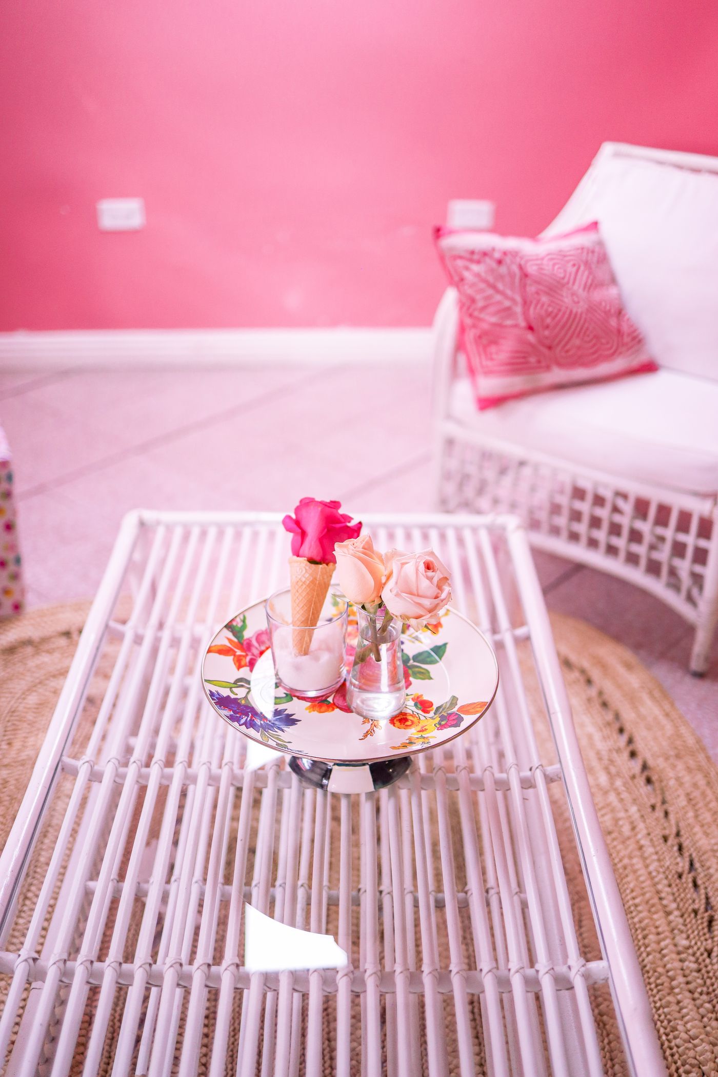 A small tray with flowers on a slatted coffee table.