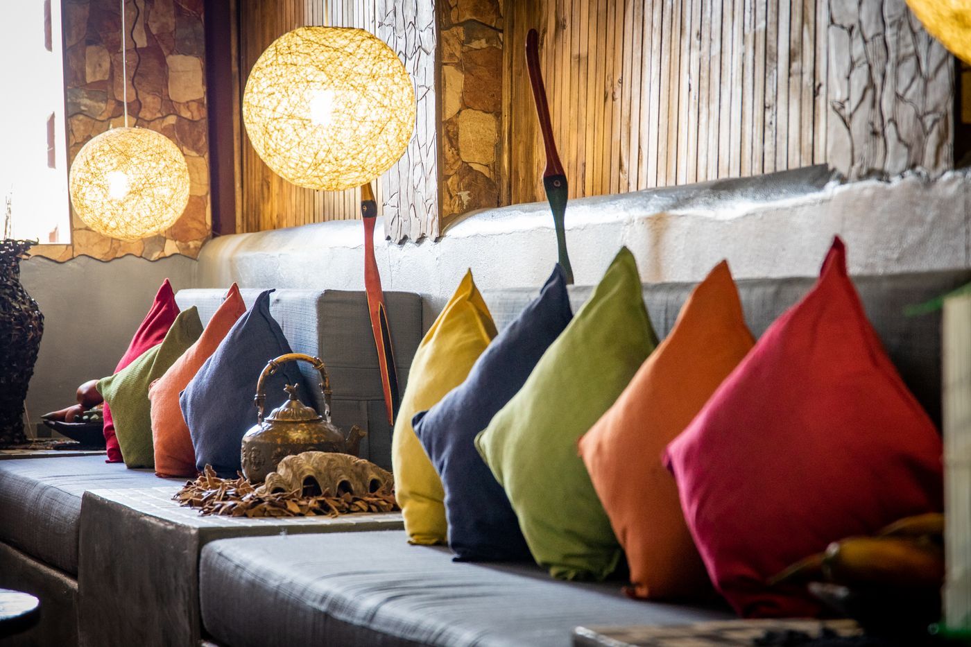 Colourful cushions arranged along a sofa.
