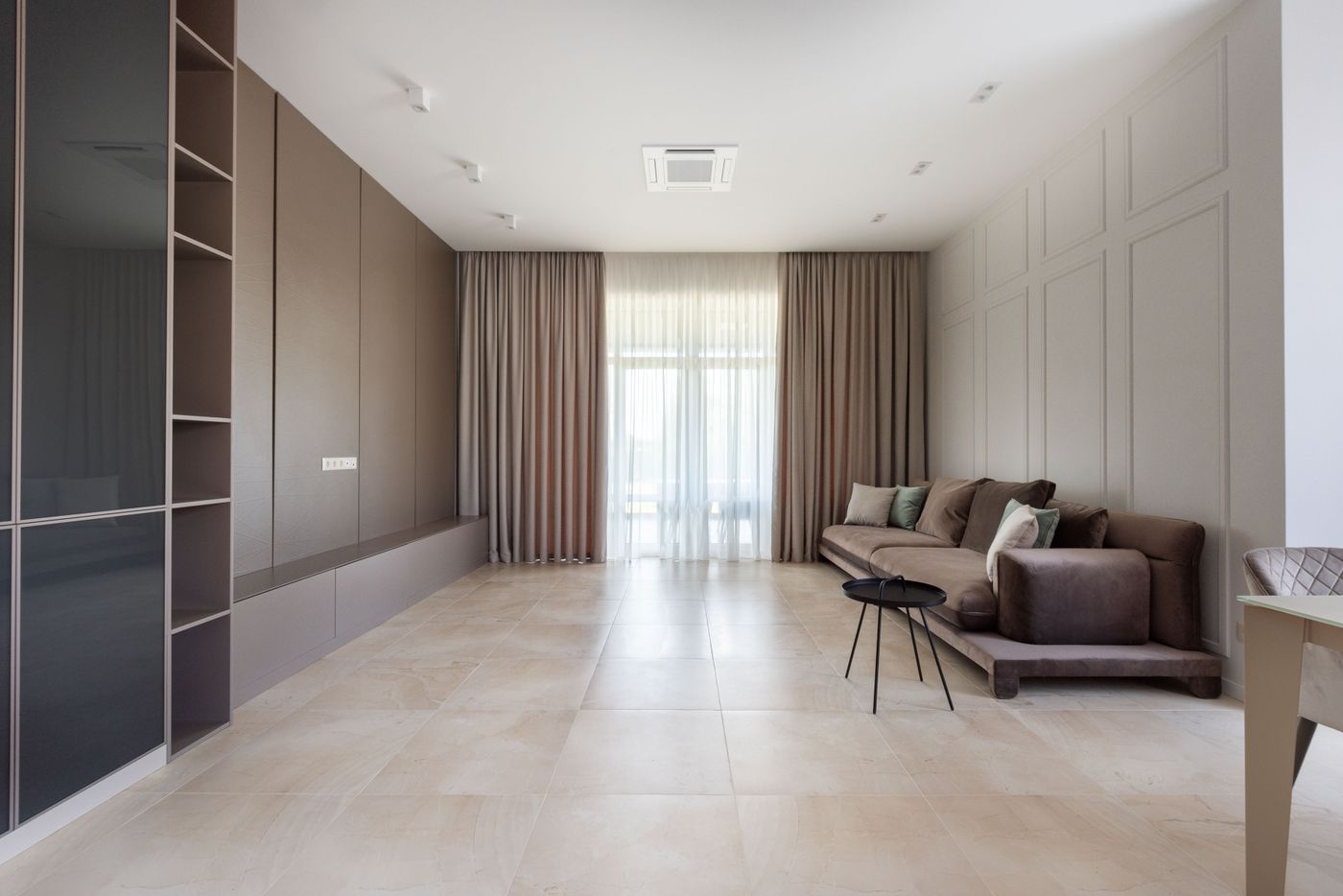 Full-length curtains meeting the floor in a bright living room.