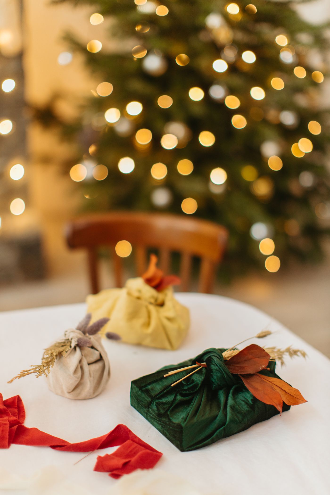 Small gifts wrapped and knotted in colourful pieces of fabric.
