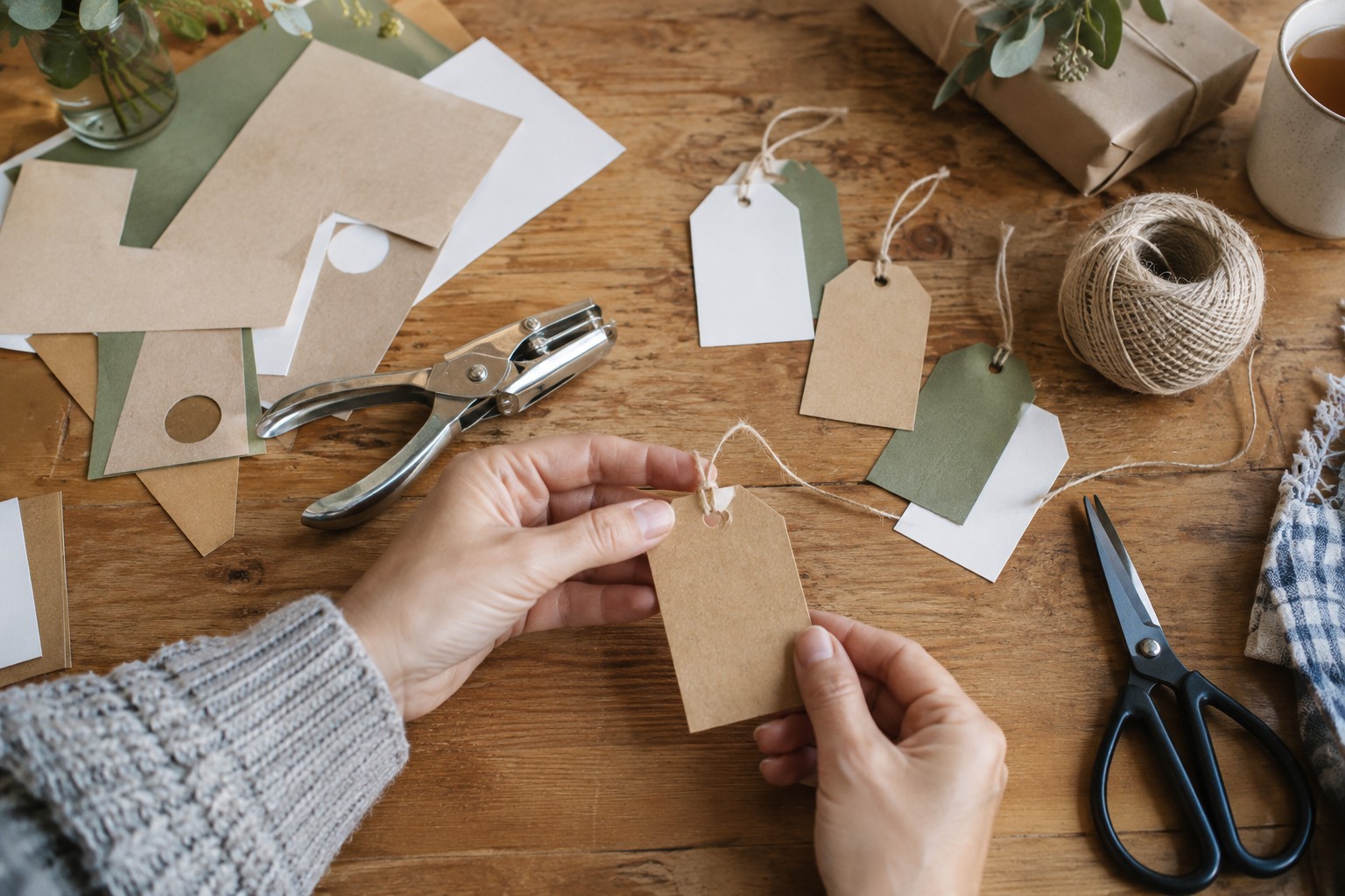 Gift tags being cut and threaded from spare card.