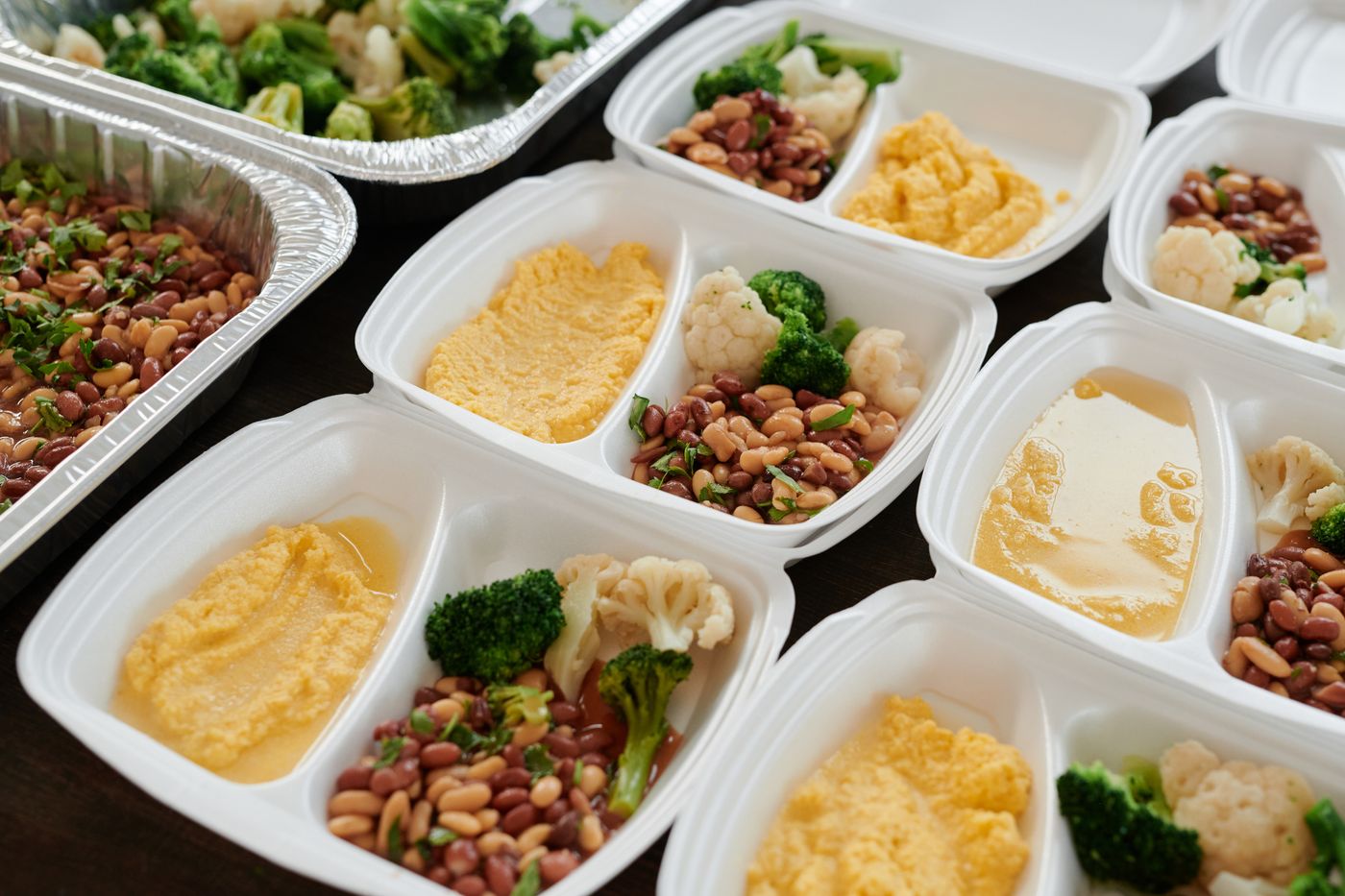 Individual meal containers holding separate portions of food.