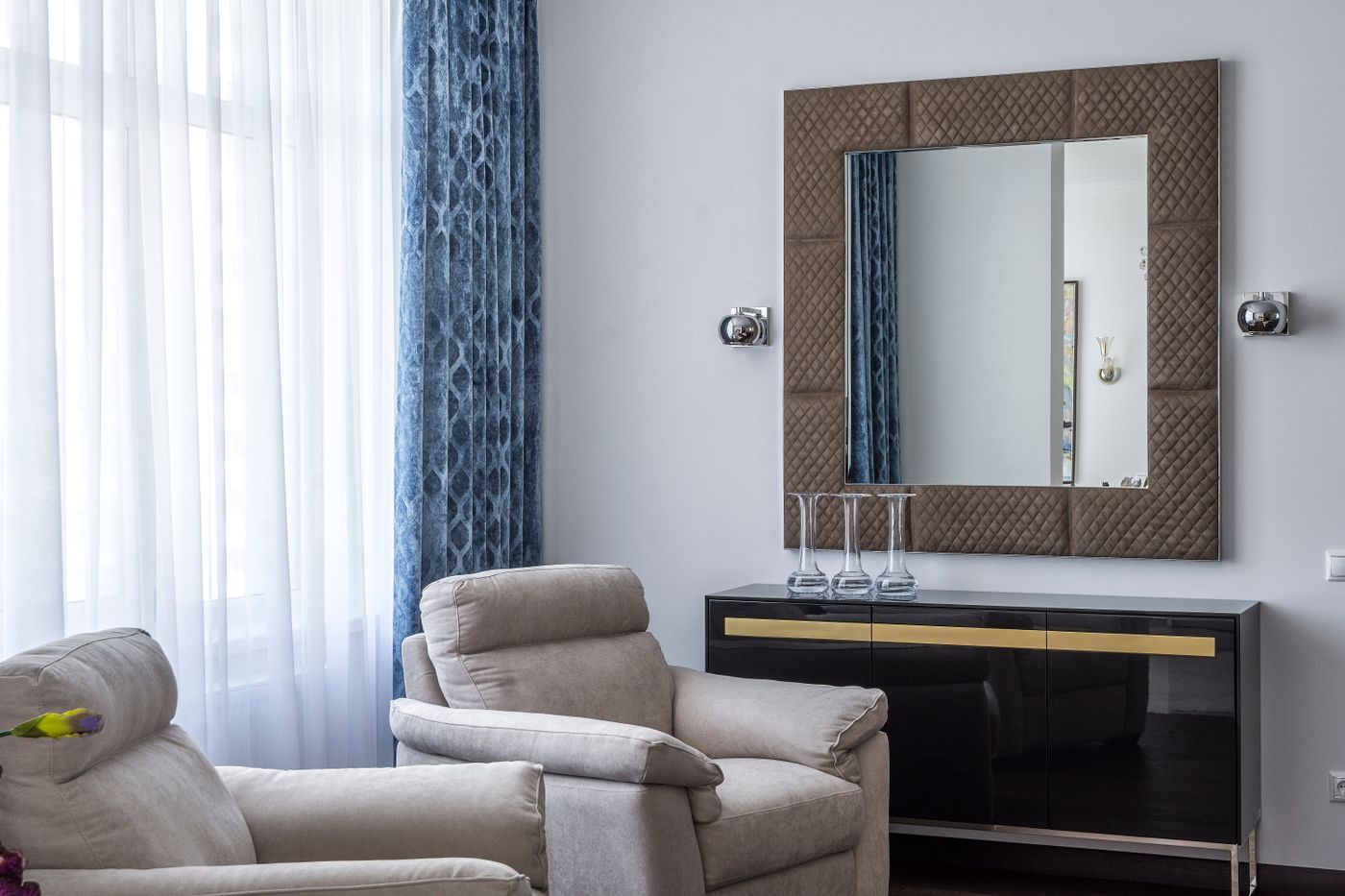 A large wall mirror above a console in a living room.