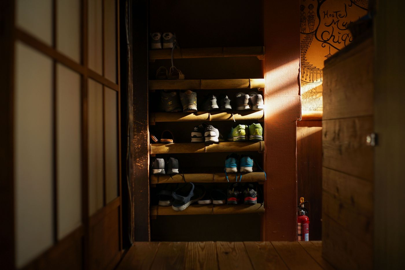 Shoes organised on an entryway rack.