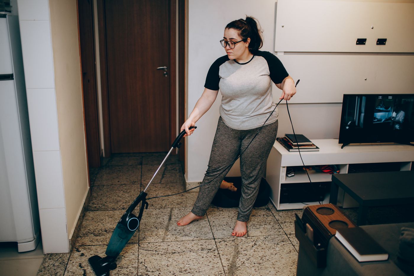 A woman vacuuming the living-room floor.
